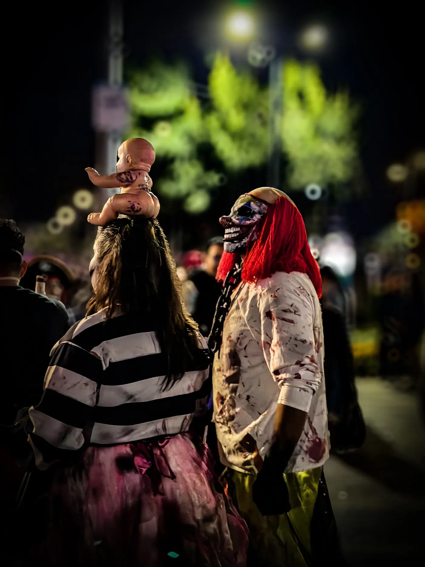Friends in detailed Halloween costumes and theatrical makeup