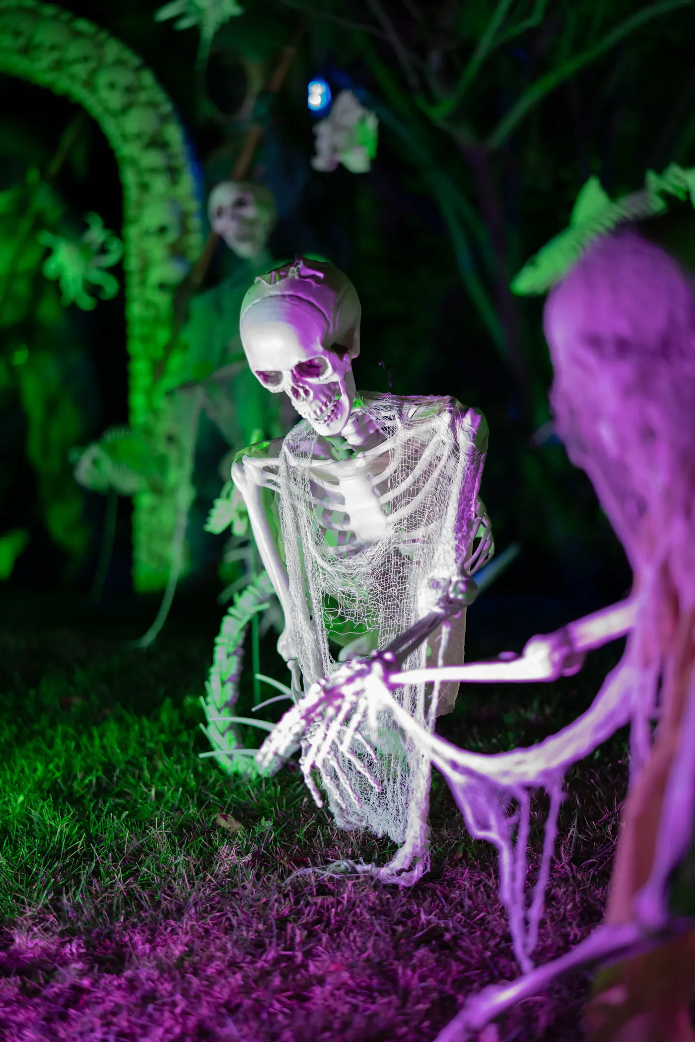 Skeleton props arranged in a moody Halloween display